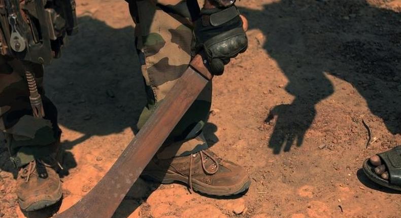 A French soldier takes a machete away from resident in Bossangoa, north of the capital Bangui, January 2, 2014. REUTERS/Andreea Campeanu