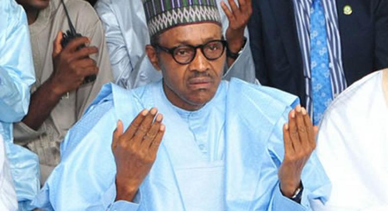 President Muhammadu Buhari praying at a mosque [Premium Times]