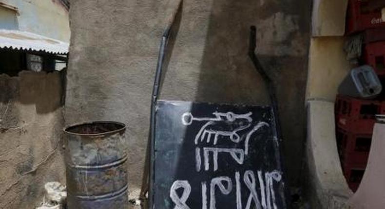 A signboard rests against a wall in a compound in Michika town, after the Nigerian military recaptured it from Boko Haram, in Adamawa state May 10, 2015.