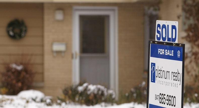 A sold sign stands in front of a single-family home in Park Ridge, Illinois.