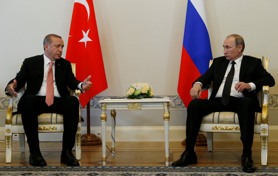 Turkish President Tayyip Erdogan speaks to Russian President Vladimir Putin (R) during their meeting in St. Petersburg, Russia, August 9, 2016.