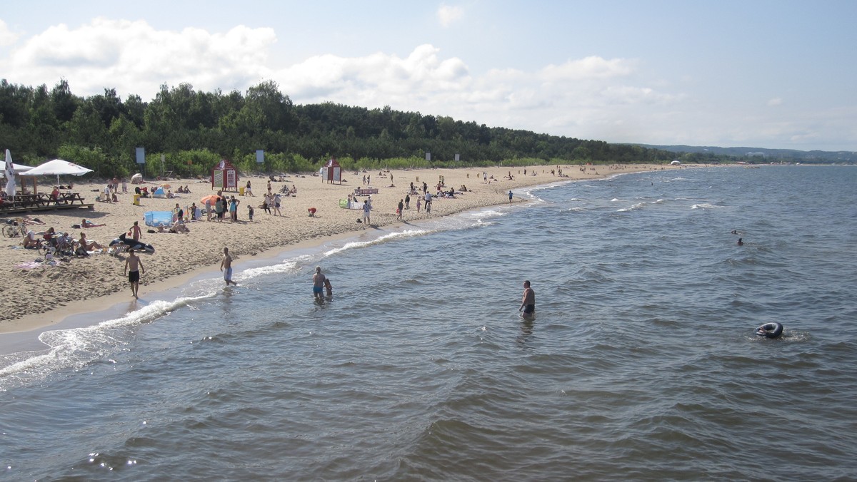 Mimo kapryśnej pogody gdańskie plaże są pełne turystów. Plażowiczów nie odstraszają nawet sinice, które w ostatnich dniach pojawiły się w wodach Zatoki Gdańskiej. Dobra informacja jest taka, że w tej chwili otwarte są już wszystkie gdańskie plaże, które w miniony piątek zamknięto właśnie z powodu pojawienia się niebezpiecznych dla zdrowia sinic.