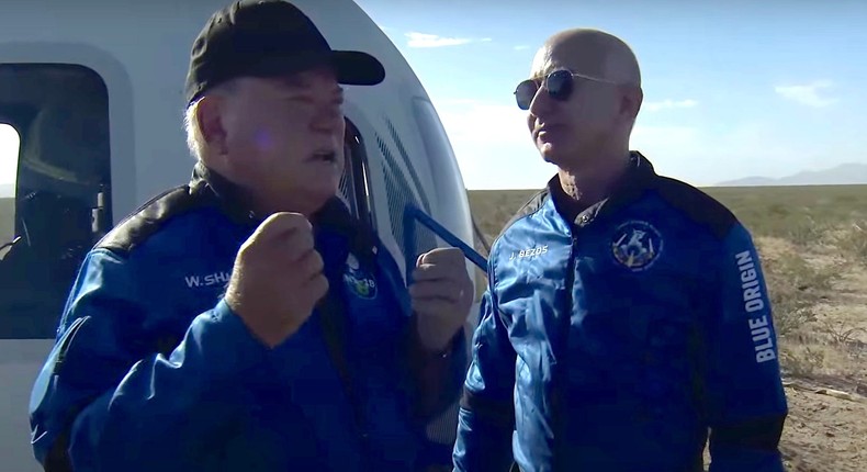 William Shatner tells Jeff Bezos about his spaceflight experience in a screenshot from Blue Origin's livestream.
