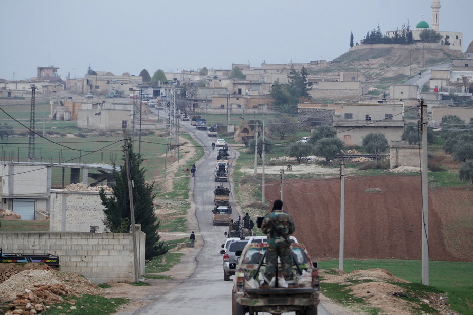 Members of the Nusra Front drive in a convoy as they tour villages, which they said they have seized control of from Syrian rebel factions, in the southern countryside of Idlib, on December 2, 2014.
