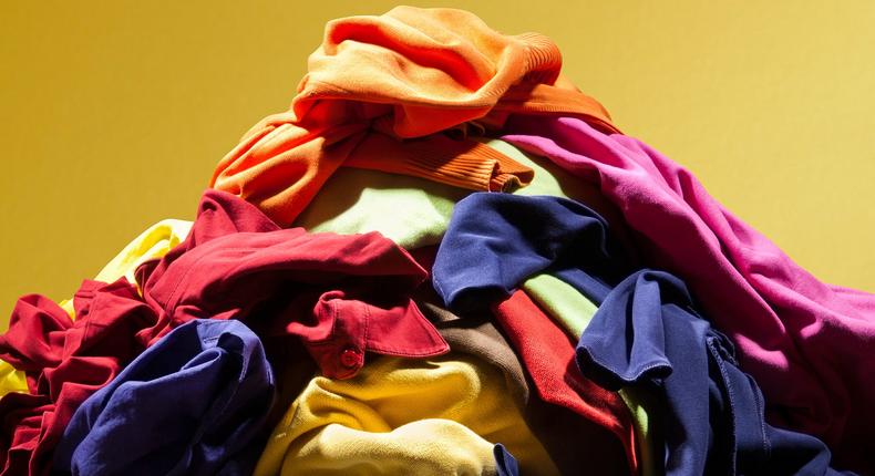Huge pile heap of dirty clothes on golden background.Getty Images