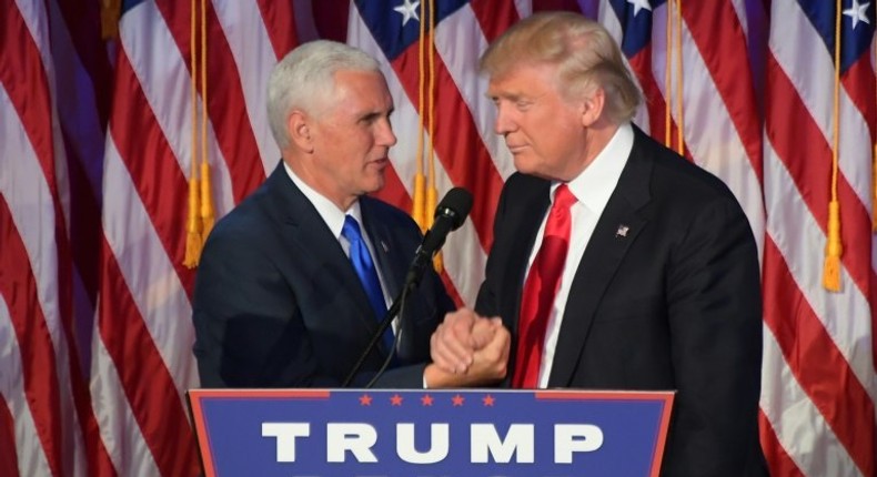 Republican presidential-elect Donald Trump (right) shakes hands with vice president-elect Mike Pence during a post election party in New York, on November 9, 2016