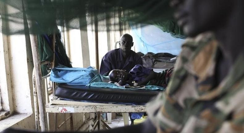 A child sick with malaria and from malnutrition lies on a bed in a hospital in Bor March 15, 2014. REUTERS/Andreea Campeanu