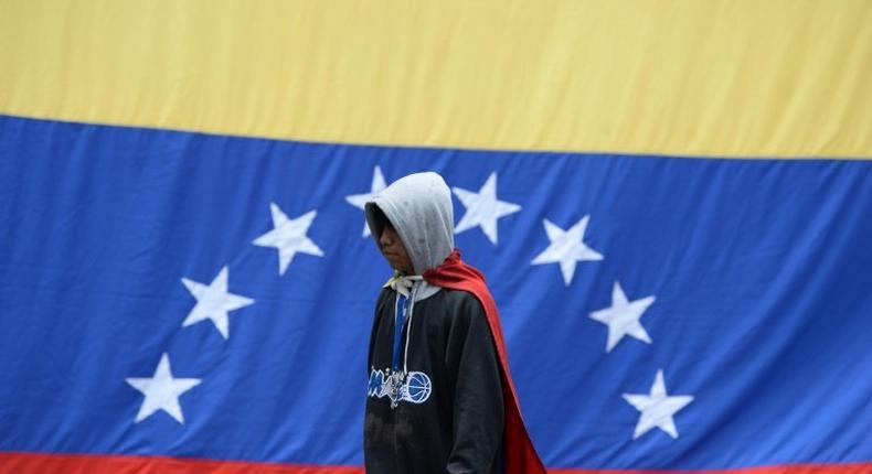 Venezuelan opposition activists protest in Caracas on July 10, 2017, demonstrations that have persisted for almost four months and left nearly 100 people dead