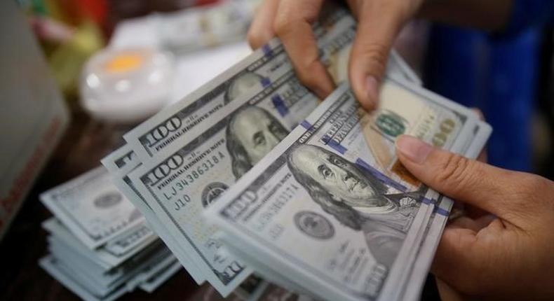 An employee of a bank counts US dollar notes at a branch in Hanoi, Vietnam May 16, 2016. REUTERS/Kham