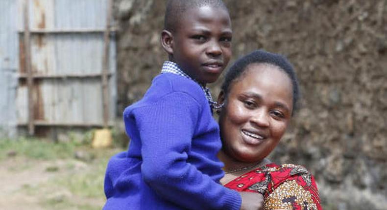 Jacqueline Khalenya embraces her son Rhonick Omondi