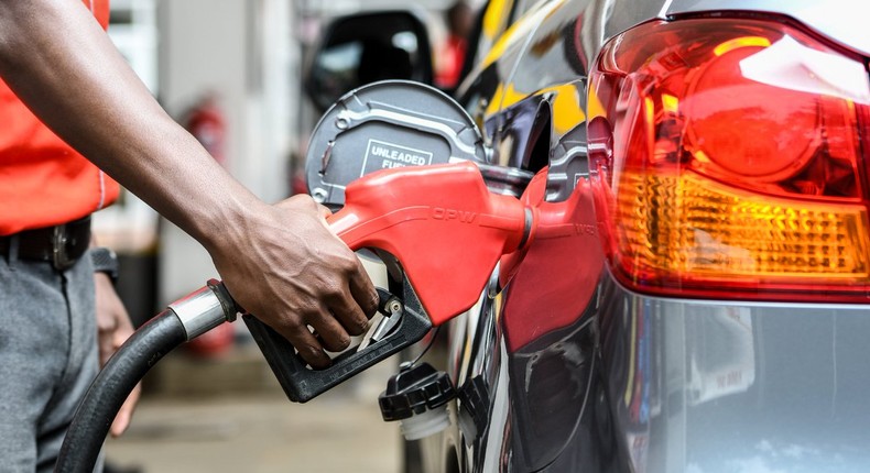 Attendant putting fuel in a car