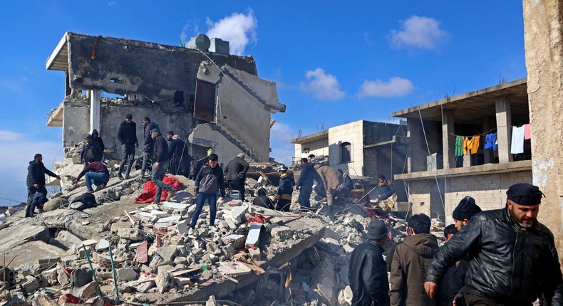 Syrians search for victims and survivors under the rubble of a collapsed building in the rebel-held town of Jindayris on February 7, 2023, following a deadly earthquake.AAREF WATAD/AFP via Getty Images