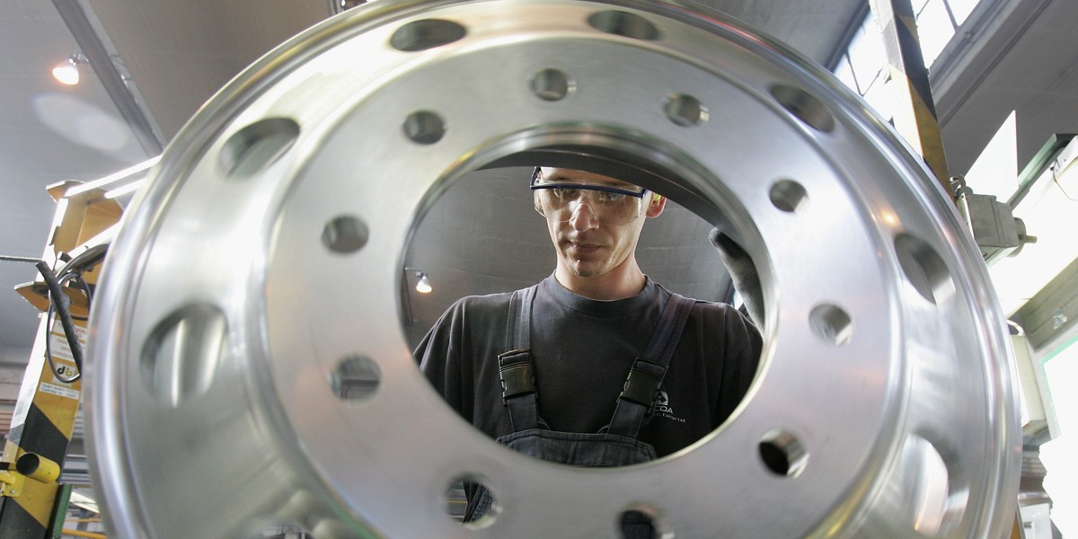 A worker performs a quality inspection on forged aluminum truck wheels along the manufacturing line at the Alcoa aluminum factory October 24, 2006 in Szekesefehervar, Hungary. Alcoa bought the factory, once one of the main suppliers of semi-finished aluminum in the former East Bloc, in 1993.