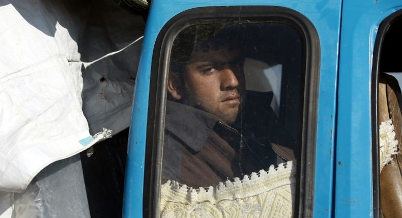 A displaced Syrian man waits inside a truck carrying his family's belongings at a checkpoint near the town of Manbij, northern Syria on March 6, 2017