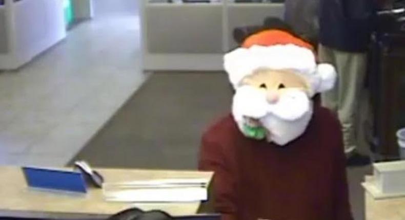 Santa Claus gives out candy before robbing a bank in America.