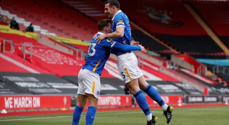 Brighton defender Lewis Dunk (right) celebrates scoring against Southampton