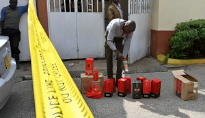 A Kenya Revenue Authority (KRA) official inspects packages of liquor that were seized on January 8, 2019 at a residential estate in Nairobi. Photo credit: Tony Karumba /AFP via Getty Images