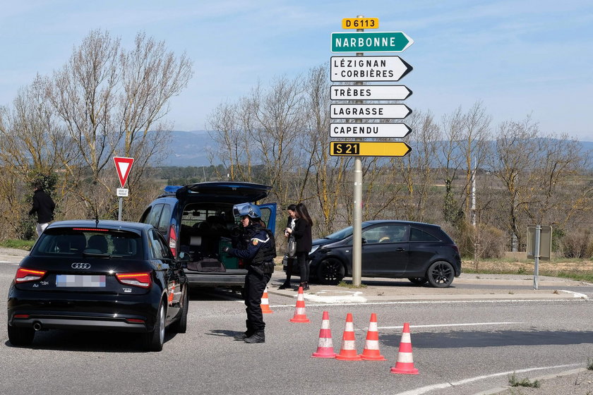 Police are seen at the scene of a hostage situation in a supermarket in Trebes