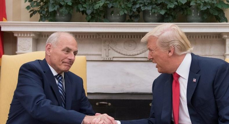 US President Donald Trump (R) shakes hands with newly sworn-in White House Chief of Staff John Kelly