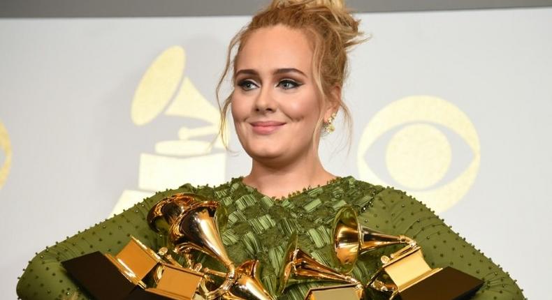 Adele holds five Grammy trophies, including the top two awards of the night, Album and Record of the Year for her blockbuster hit Hello and the album 25