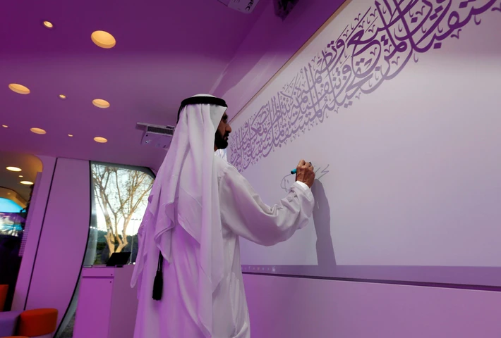 Sheikh Mohammed bin Rashid Al Maktoum signs on the board during the official opening of the world's 