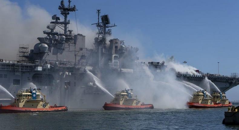 Firefighters battle a fire aboard the US Navy amphibious assault ship USS Bonhomme Richard
