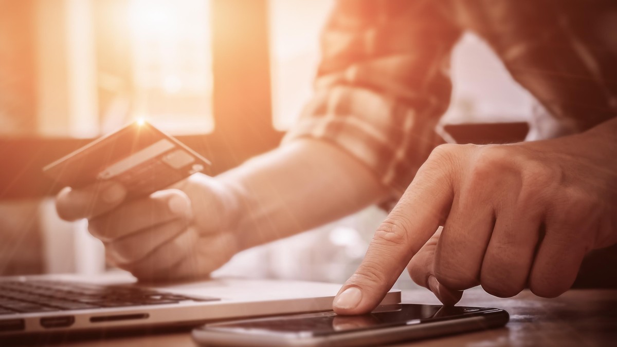 Online payment,Man's hands pointing smartphone and using credit card for online shopping.