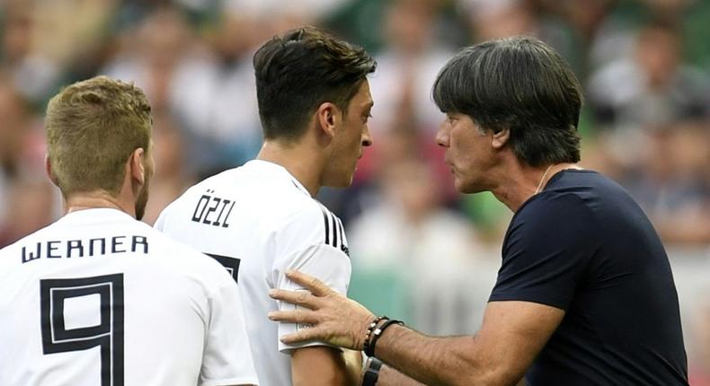 Departing Germany head coach Joachim Loew (R) wants to hold talks with midfielder Mesut Ozil (C) Creator: Patrik STOLLARZ