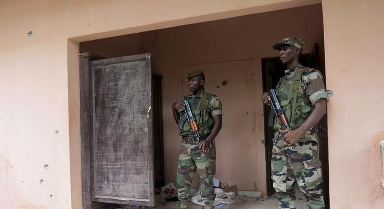 Malian soldiers stand guard in a file photo. REUTERS/Adama Diarra