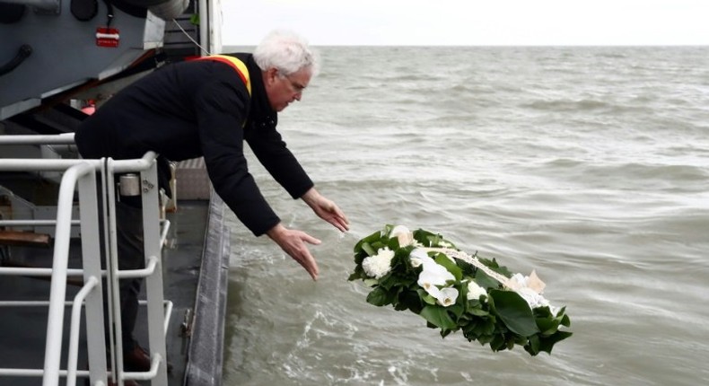 West-Flanders province governor Carl Decaluwe throws a wreath to the sea during a tribute ceremony for the 30th anniversary of the Herald of Free Enterprise ferry disaster