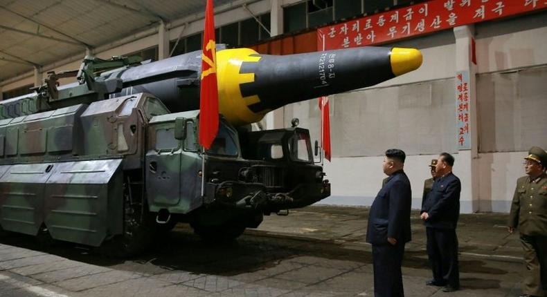 North Korean leader Kim Jong-Un (3rd R) inspects a ground-to-ground medium long-range strategic ballistic rocket Hwasong-12 at an undisclosed location