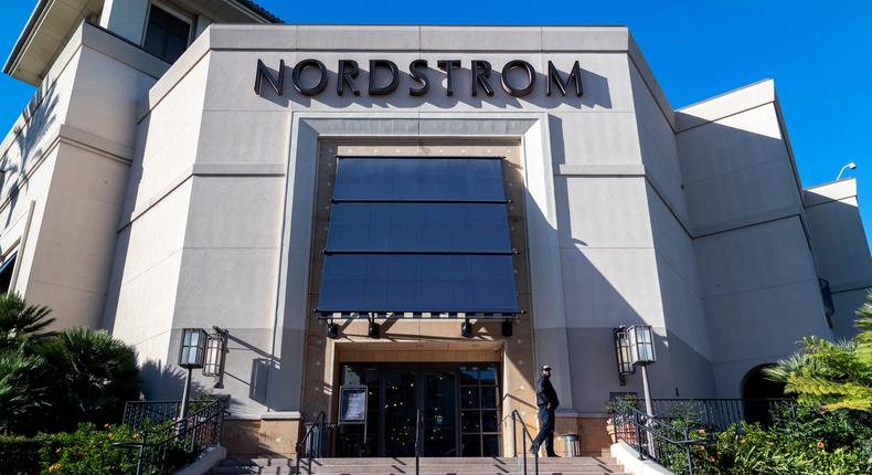 A security guard patrols the front entrance of Nordstrom on Tuesday after an organized group of thieves attempted a smash-and-grab robbery late Monday night at The Grove location November 23, 20201 in Los Angeles, California.