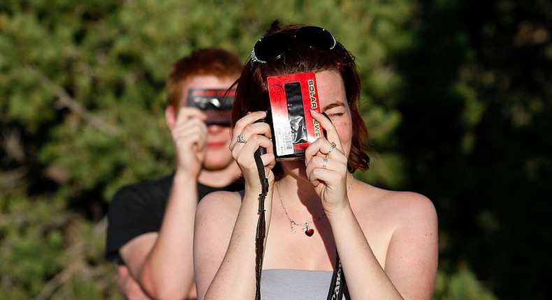 People use solar film to photograph the first annular eclipse seen in the U.S. since 1994 on May 20, 2012 in Grand Canyon National Park, Arizona.