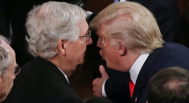 Senate Majority Leader Mitch McConnell and President Donald Trump huddle after the State of the Union Address in Washington, DC, on February 4, 2020.
