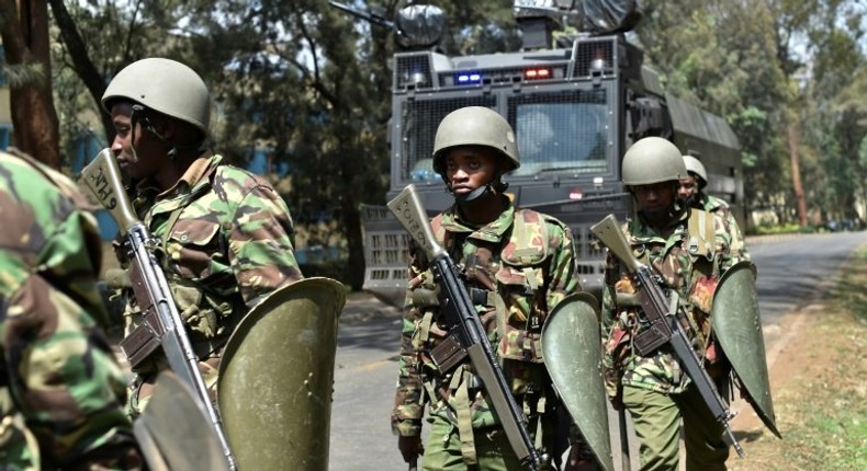 Kenyan riot police patrol a street after dispersing University of Nairobi students protesting in Nairobi on September 28, 2017