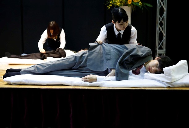 Funeral undertakers dress models during an encoffinment competition at Life Ending Industry EXPO 201