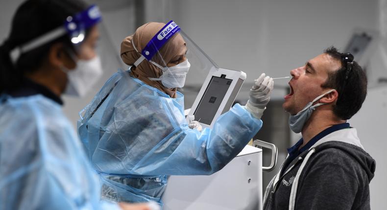 A man takes a COVID-19 test at Sydney International Airport on November 28, 2021.