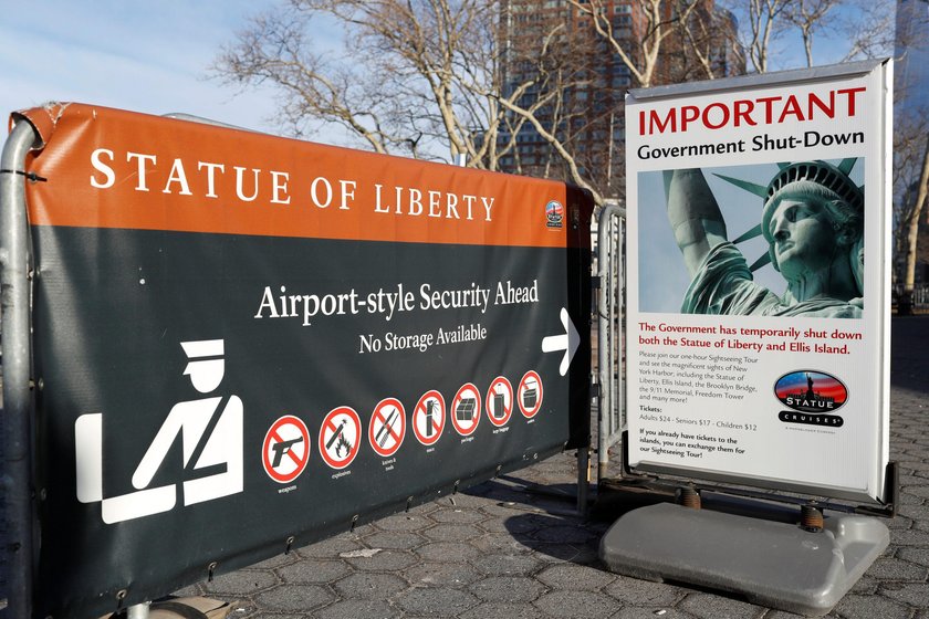 A sign announcing the closure of the Statue of Liberty, due to the U.S. government shutdown, sits ne