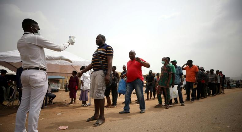 People at the border between Abuja and Nasarawa state waited to have their temperature checked