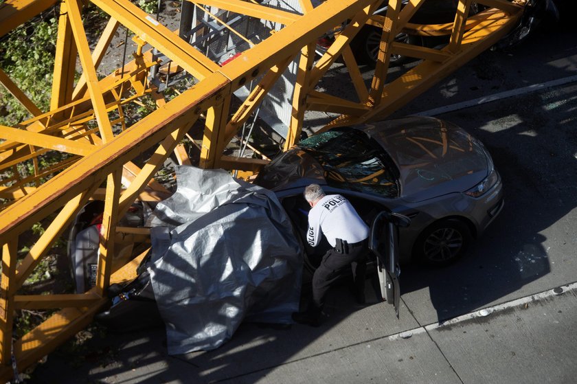 Part of a construction crane that fell in a deadly accident is removed from the scene on Mercer Stre