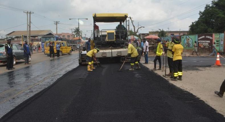 Men of the Lagos State Public Works Corporation (LSPWC) rehabilitating a road. [NAN]