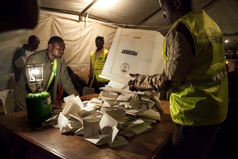 Staff from the Independent Electoral and Boundaries Commission (IEBC) empty ballots for counting at a polling station at the Kibra Social Grounds in Nairobi on March 4, 2013 during the elections. (Photo by Georgina Goodwin/AFP via Getty Images)
