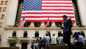 People sit outside the New York Stock Exchange (NYSE) in New York City, U.S., September 15, 2016.Brendan McDermid/Reuters