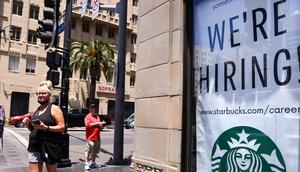 A 'We're Hiring!' sign is displayed at a Starbucks on Hollywood Boulevard on June 23, 2021 in Los Angeles, California.Mario Tama/Getty Images
