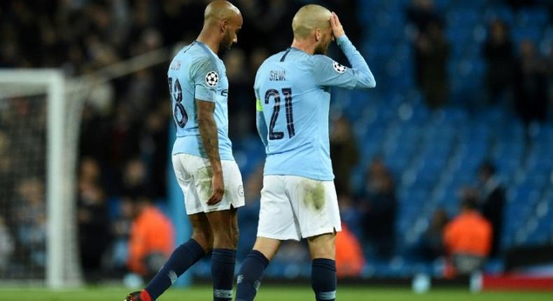 Manchester City's Fabian Delph and David Silva show the strain of their shock defeat to Lyon