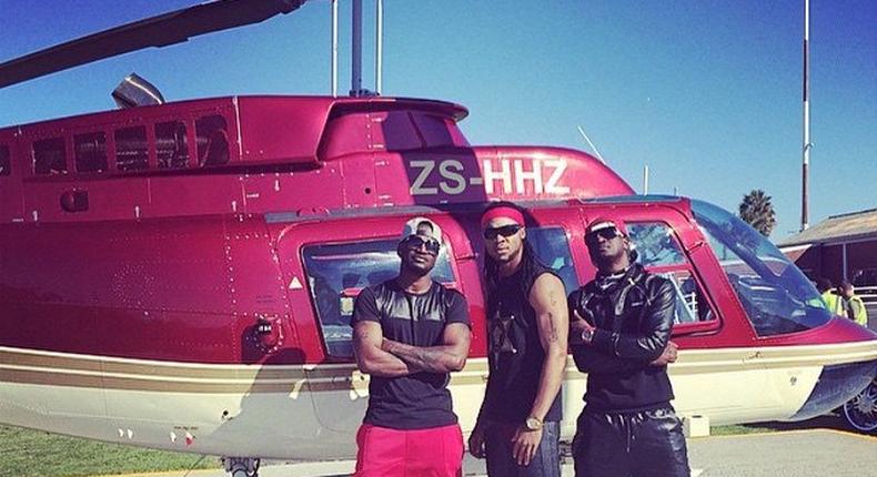 Psquare and Flavour in front of a chopper at the music video shoot