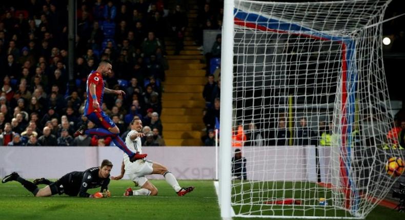 Manchester United's striker Zlatan Ibrahimovic (R) slides the ball into the goal to score their second goal during the English Premier League football match between Crystal Palace and Manchester United on December 14, 2016