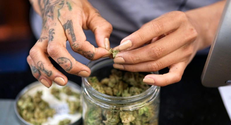 A budtender weighs out marijuana for a customers at ShowGrow, a medical marijuana dispensary in downtown Los Angeles.
