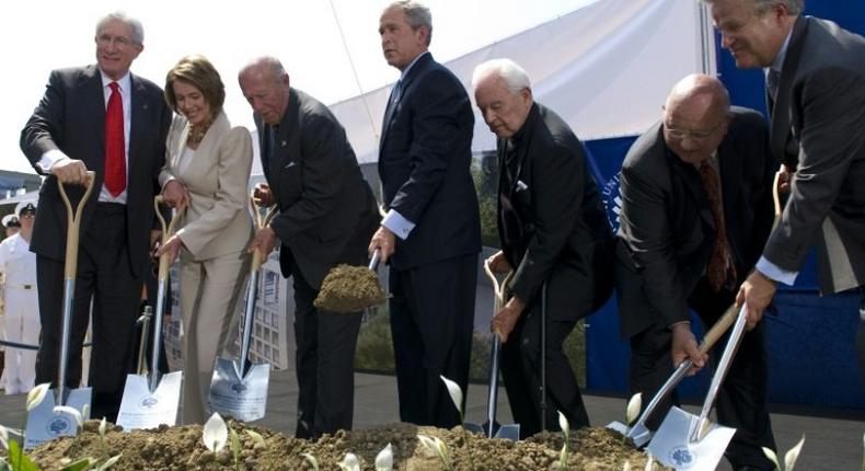 Top US diplomat and China scholar Richard Solomon, pictured (L) at a ground breaking ceremony with president George W. Bush (C)in 2008, has died aged 79