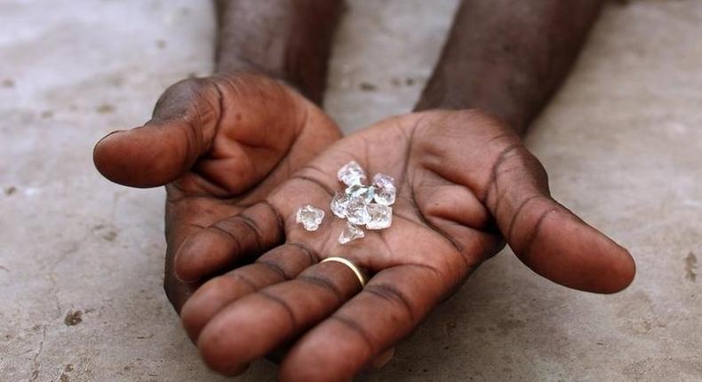 An illegal diamond dealer from Zimbabwe displays diamonds for sale in Manica, near the border with Zimbabwe, September 19, 2010. REUTERS/Goran Tomasevic